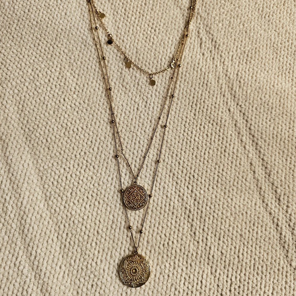 Layered gold necklace with medallions